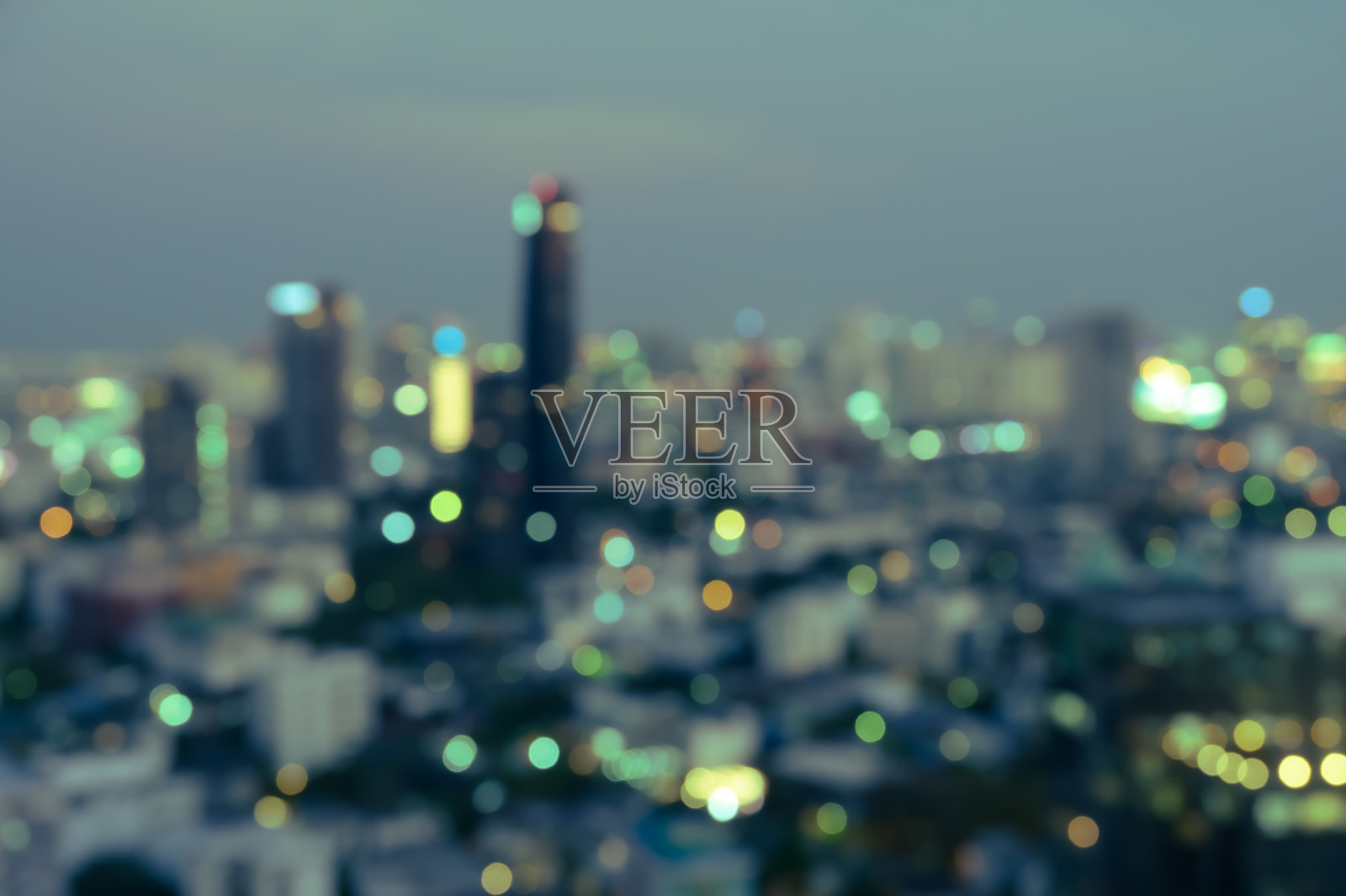 模糊的暮色中，城市办公楼的灯光，抽象的背景照片摄影图片