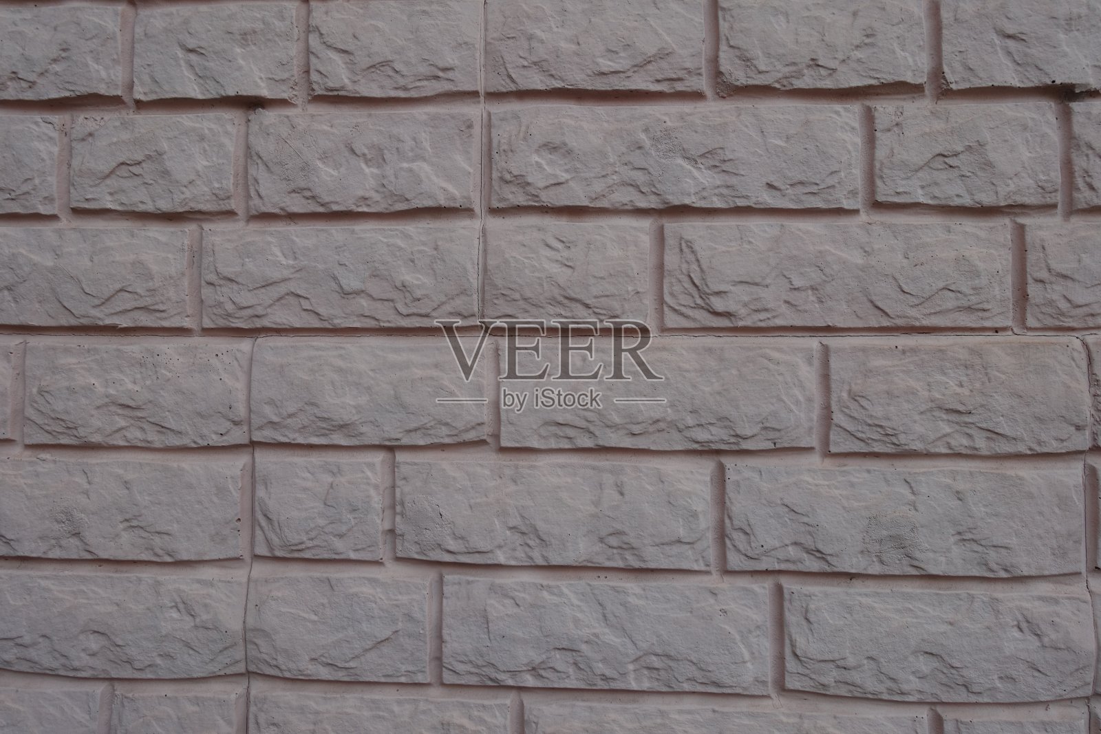 浅灰粉色彩绘砖饰面墙的纹理表面照片摄影图片