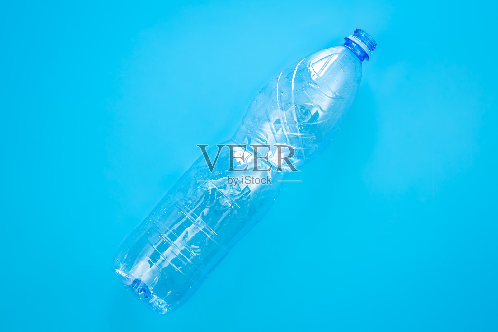 使用塑料瓶在一个蓝色的背景，俯视图，平铺。照片摄影图片