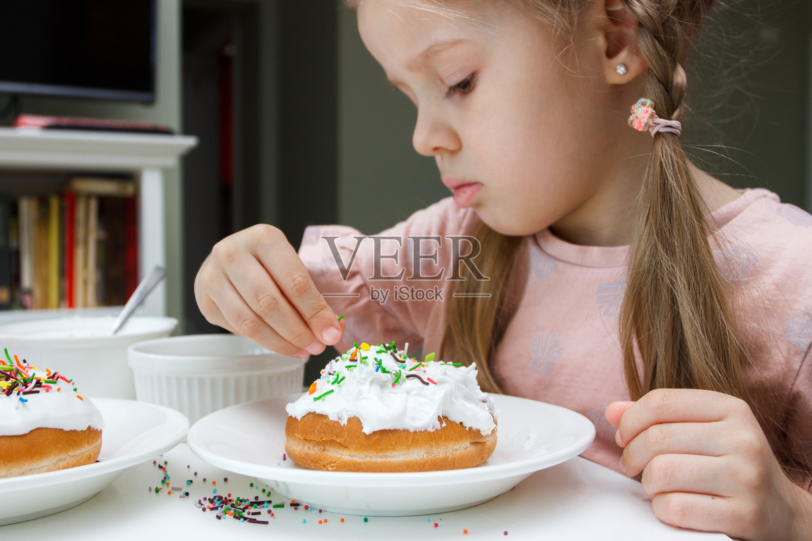 可爱的小女孩用甜美的颜色装饰蛋糕，烹饪的概念照片摄影图片