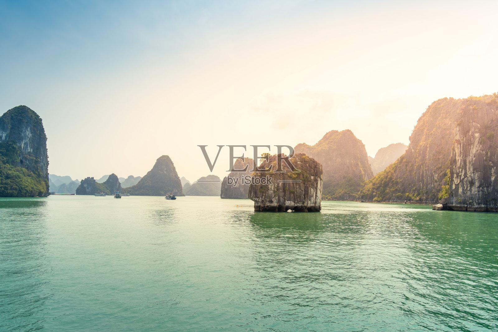越南广宁省下龙湾景观;有很多石灰岩小岛和游轮;在一个蓝天的夏日照片摄影图片