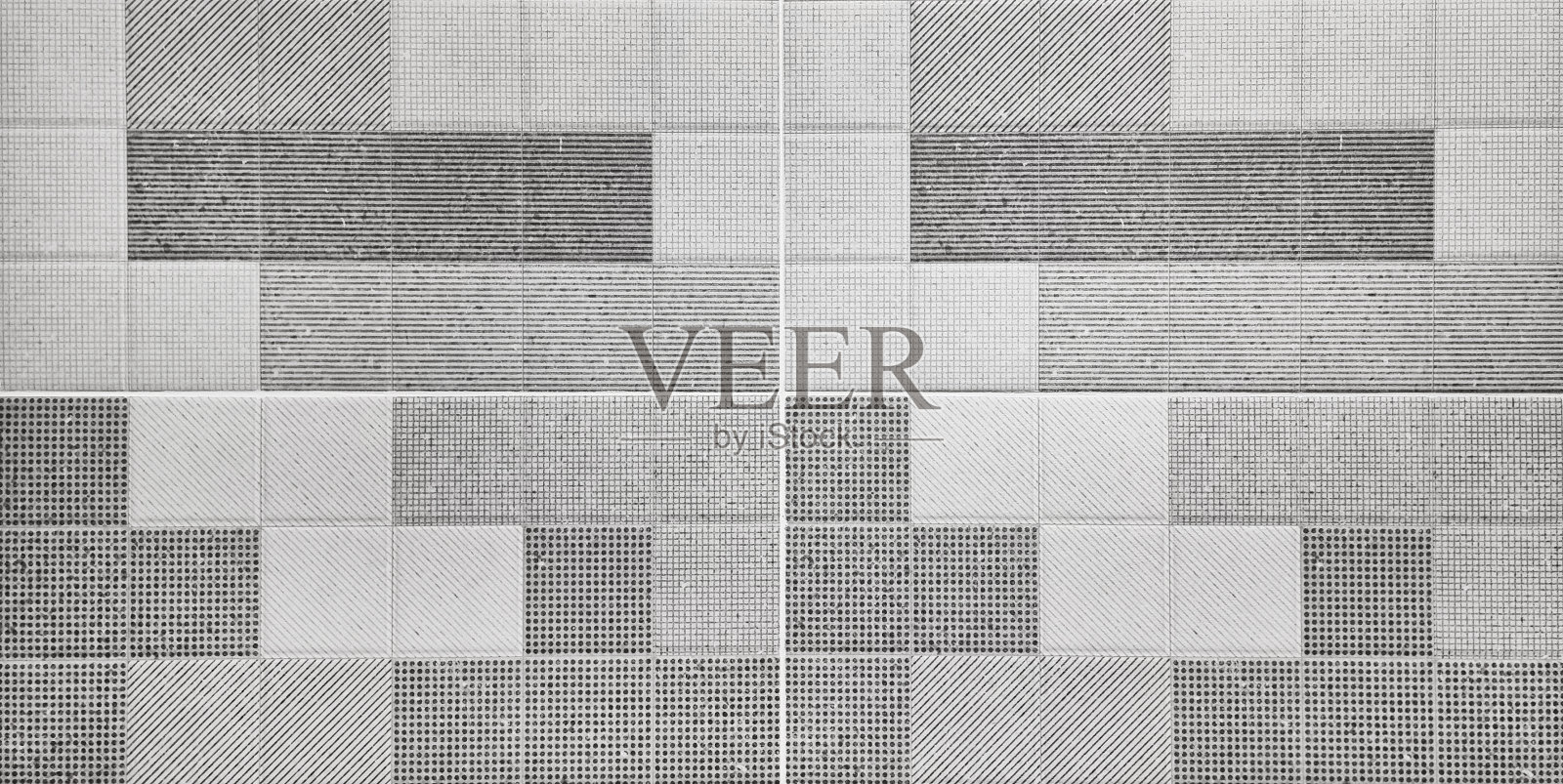 现代风格的灰色纹理图形瓷砖背景包含点、线、条纹、斜纹。重复几何瓷砖，近距离观察，为室内墙壁和地板整理。照片摄影图片