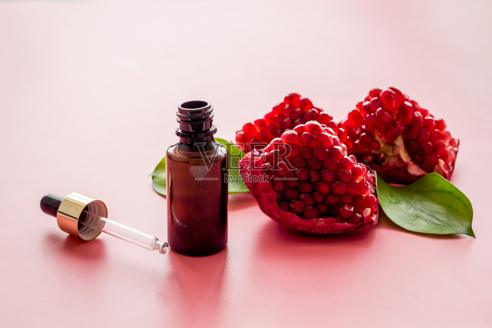 一瓶新鲜水果石榴籽精油照片摄影图片