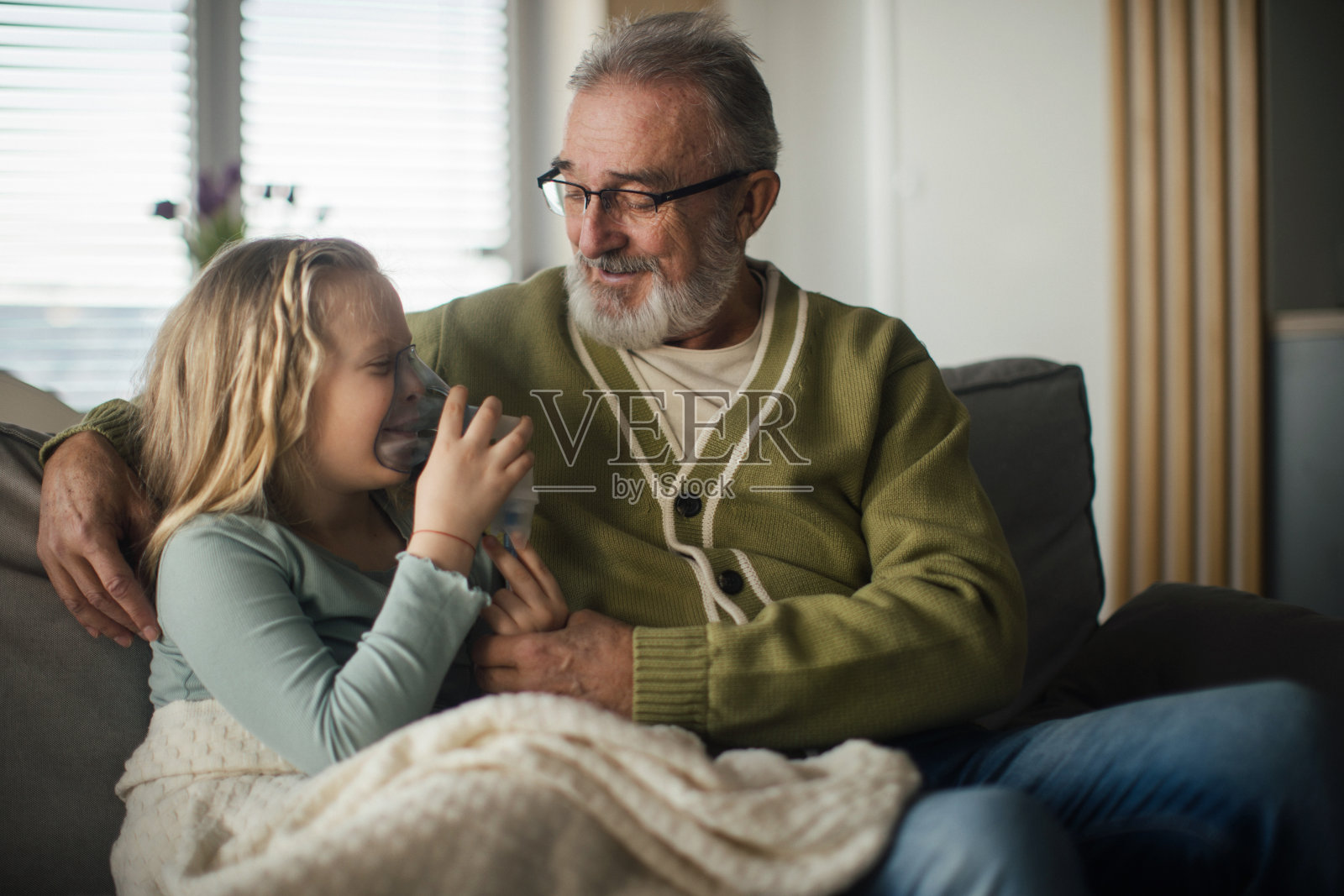 老人在照顾他生病的孙女。照片摄影图片