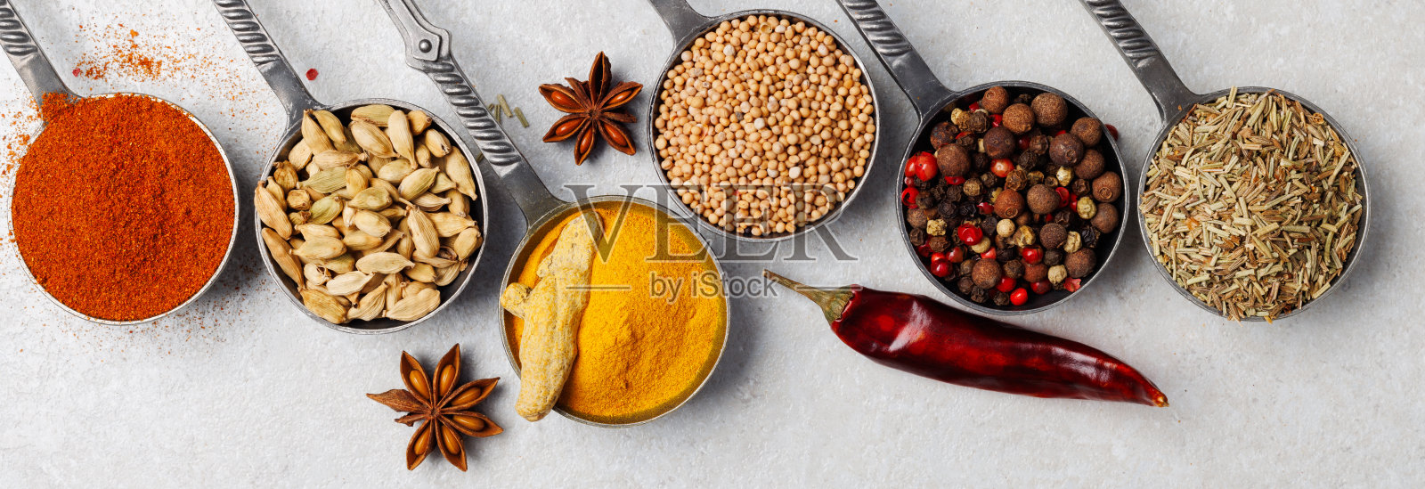 木桌上放着五颜六色的香料。前视图。平铺，留出文字空间照片摄影图片