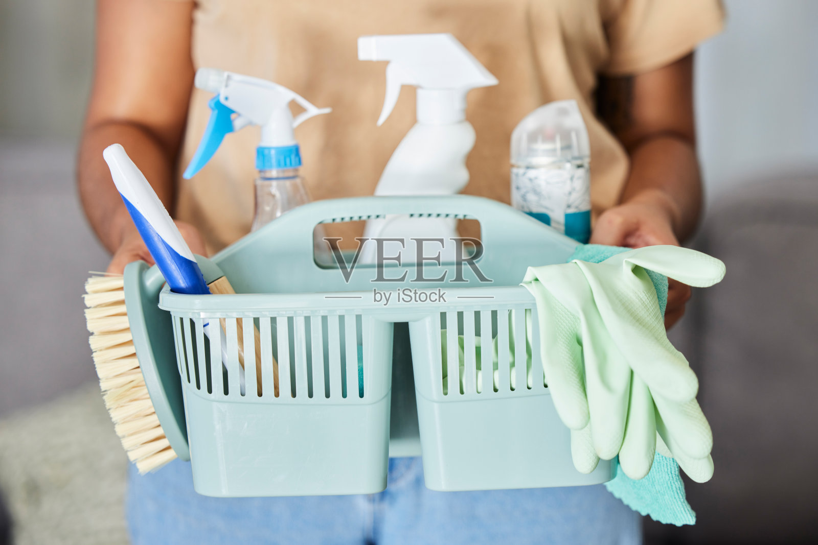 清洁，用品和篮子在女管家的手中，用于家庭卫生或消毒。Covid，服务和客房部，一名女清洁工拿着消毒剂容器照片摄影图片