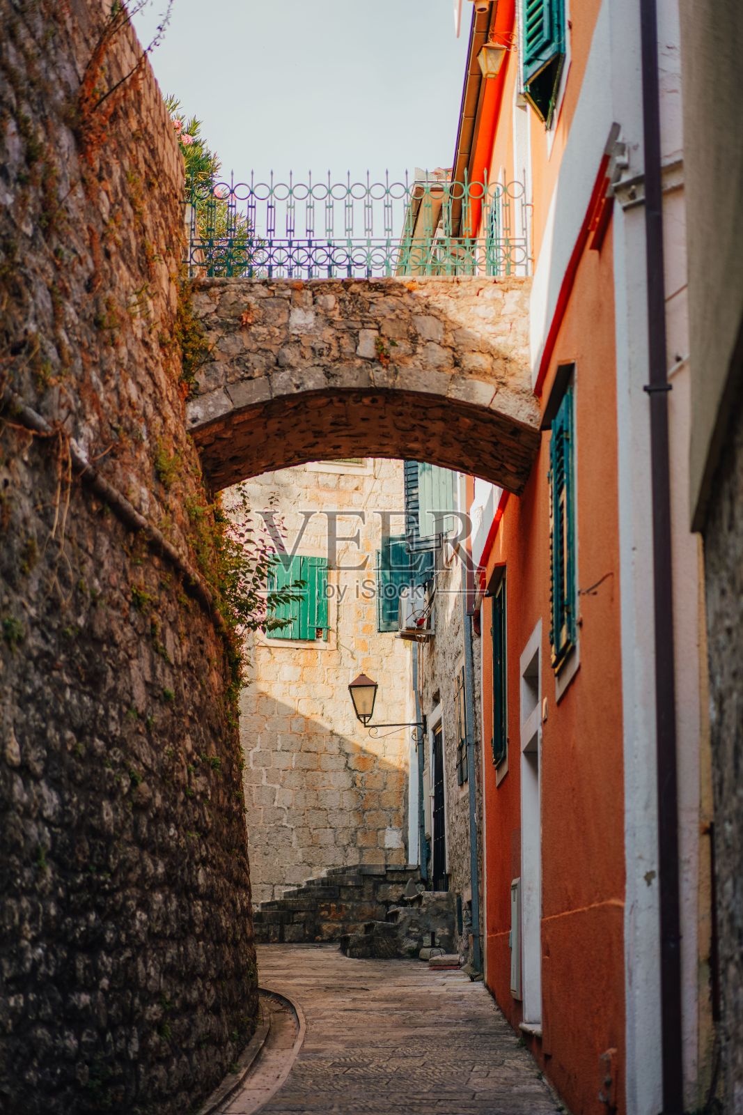 黑山赫尔切格诺维，一座石砌拱门勾勒出两栋建筑之间空荡荡的小巷照片摄影图片