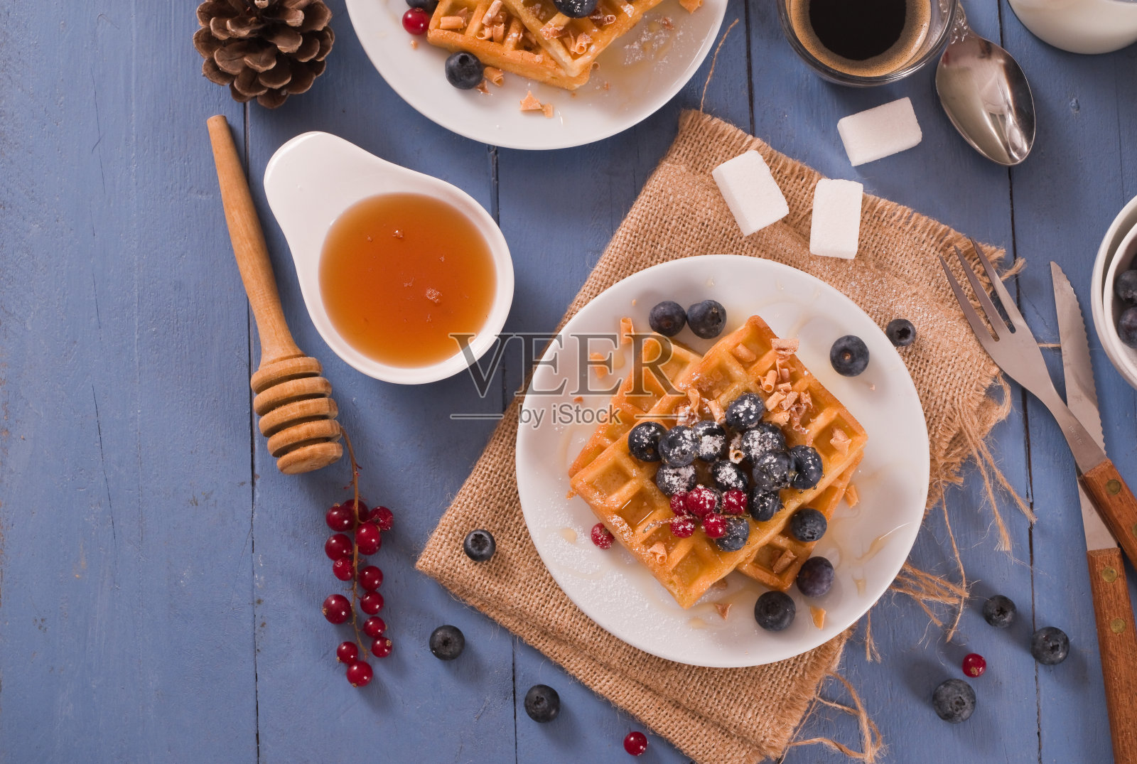 白盘配红醋栗和蓝莓华夫饼。照片摄影图片