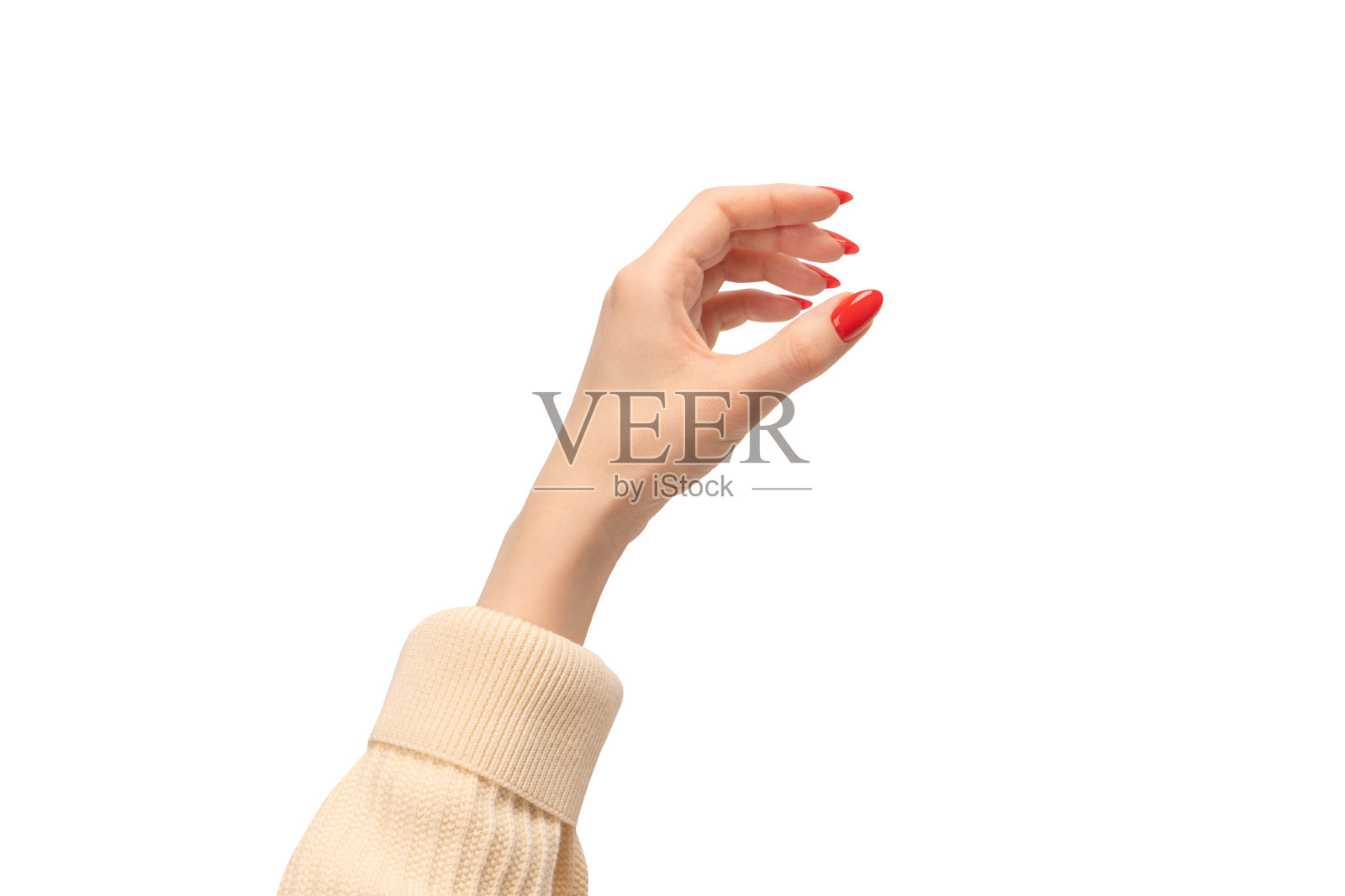 红指甲的女人手里拿着什么东西。照片摄影图片