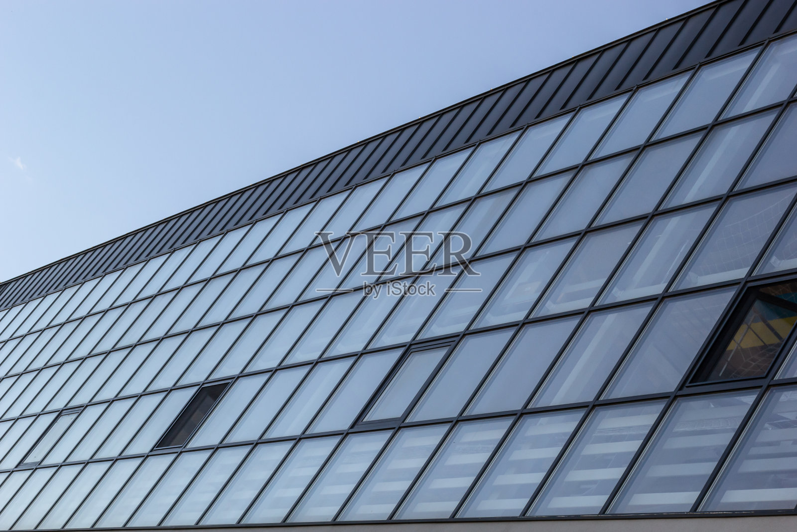 现代摩天大楼的底部视图，玻璃窗户对天空背景的宣传内容。以全新视角设计的当代商业中心照片摄影图片