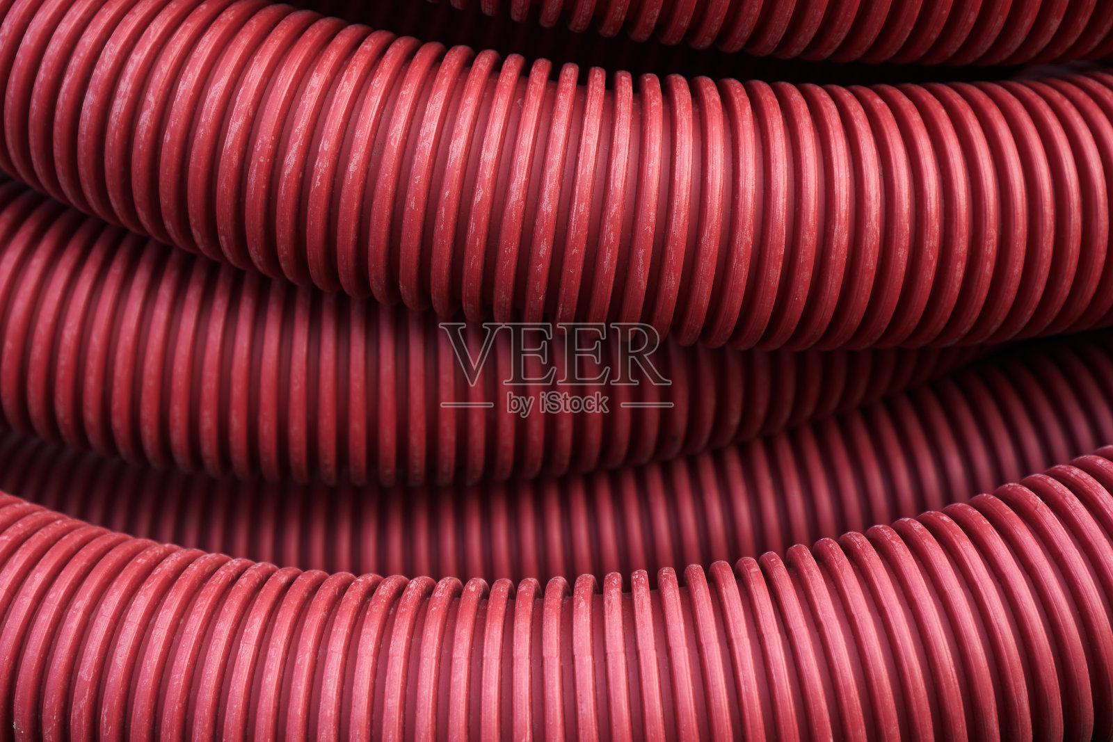 波纹用于地下电线的绝缘电缆、塑料管、建筑工程的电力保护管，红色波纹特写与复制空间。高质量照片照片摄影图片