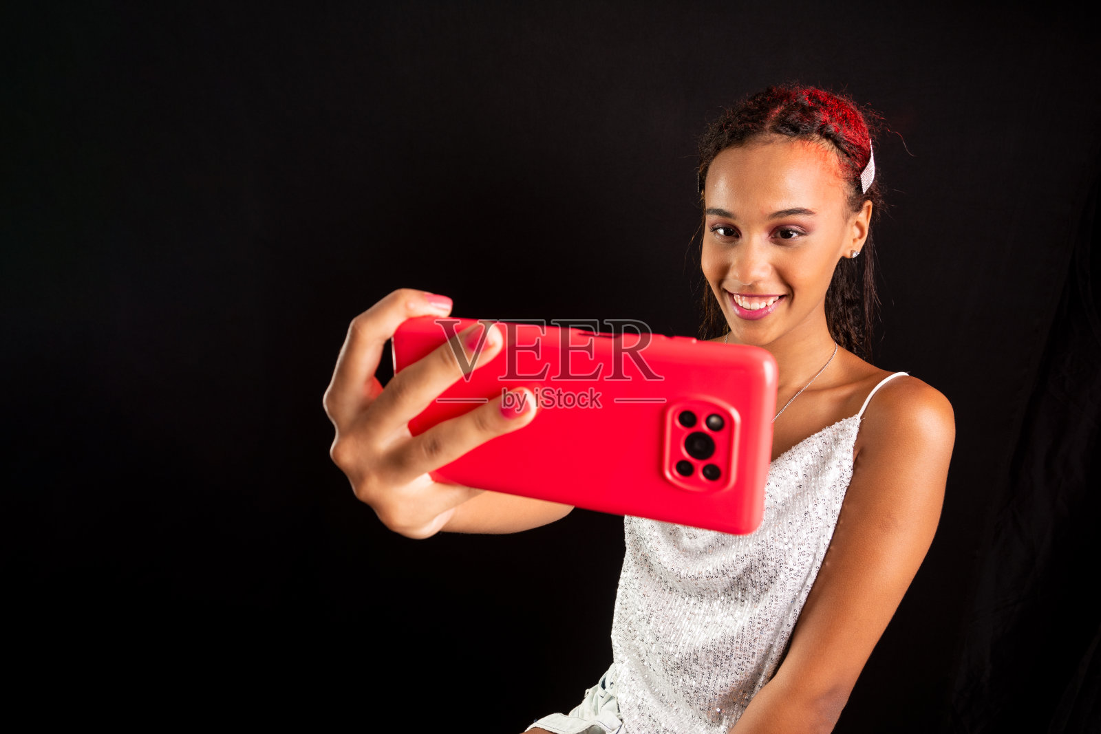 少年，微笑着，用手机自拍。照片摄影图片