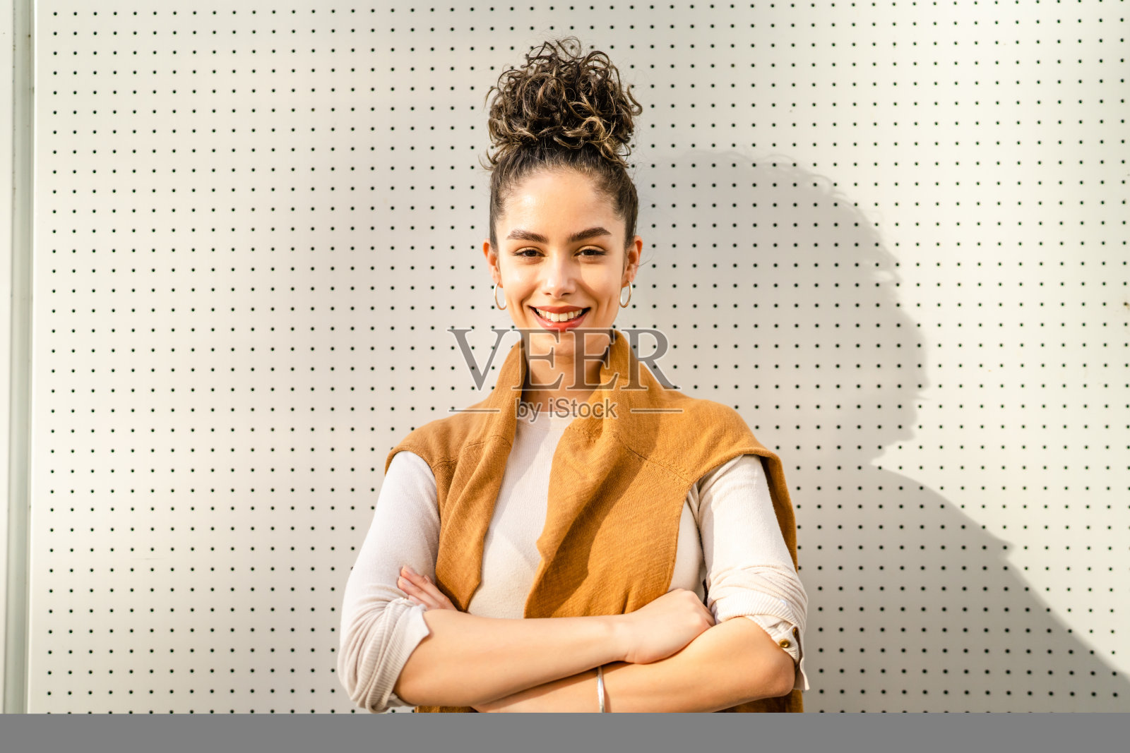 一幅年轻白人女子的肖像站在户外的白墙前照片摄影图片