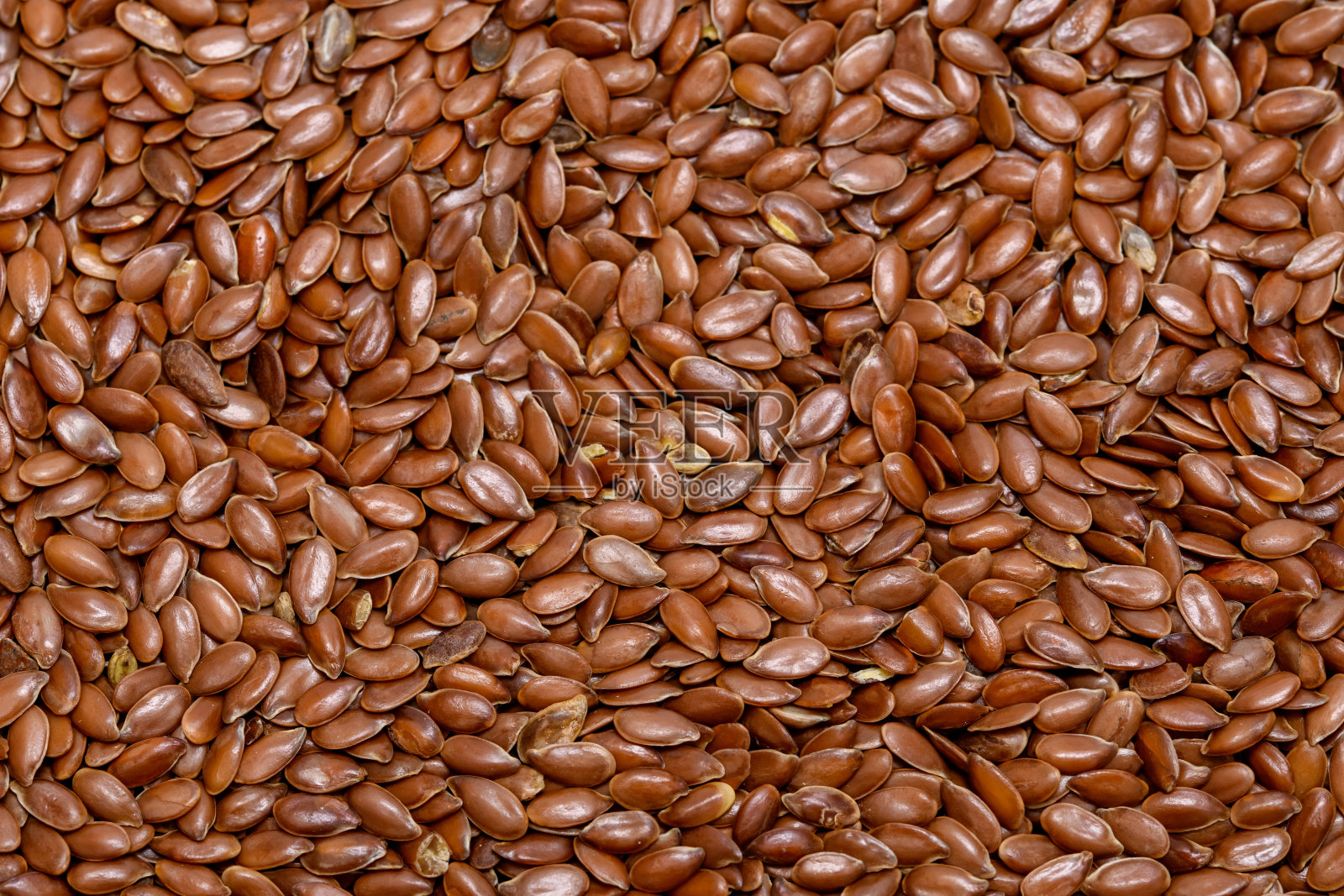 棕色背景亚麻籽，谷物，亚麻籽照片摄影图片