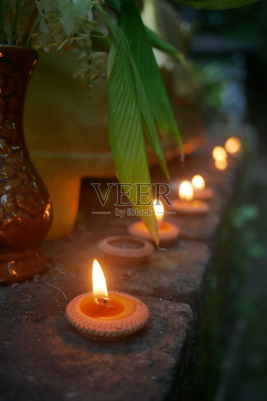 泰国佛寺外点燃的茶蜡烛特写照片摄影图片