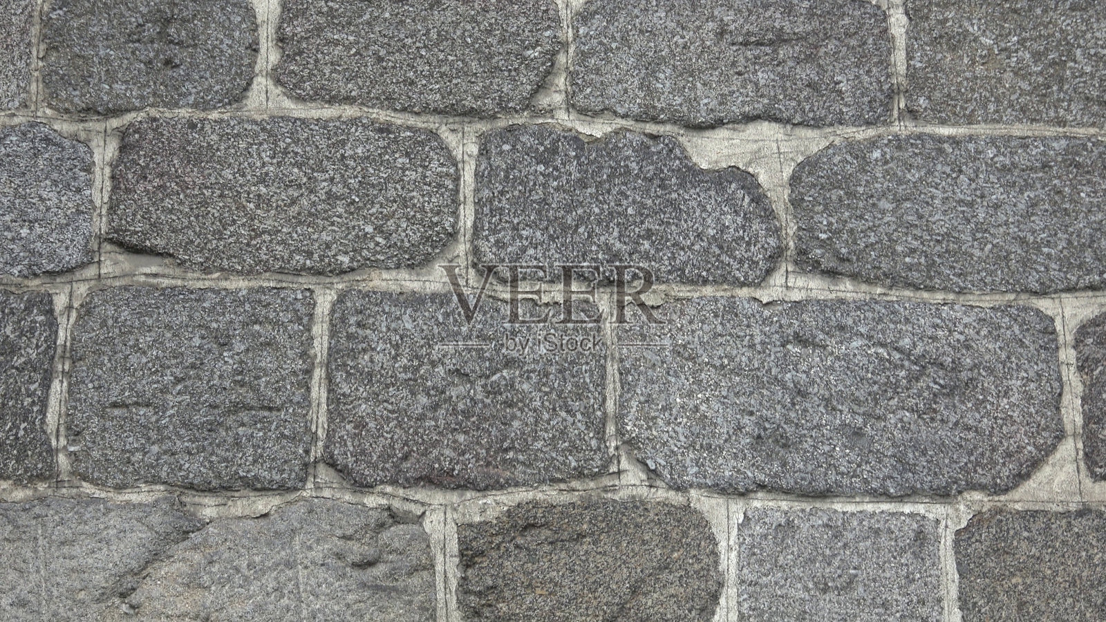 由不同大小的岩石组成的石墙的细节。照片摄影图片