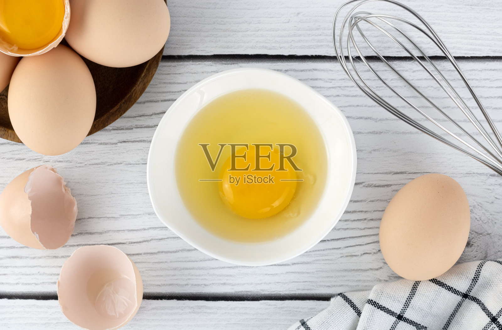 在白色背景上烹饪烘焙原料鸡蛋，打蛋器和厨房纺织品。派或蛋糕食谱。前视图。副本的空间。照片摄影图片