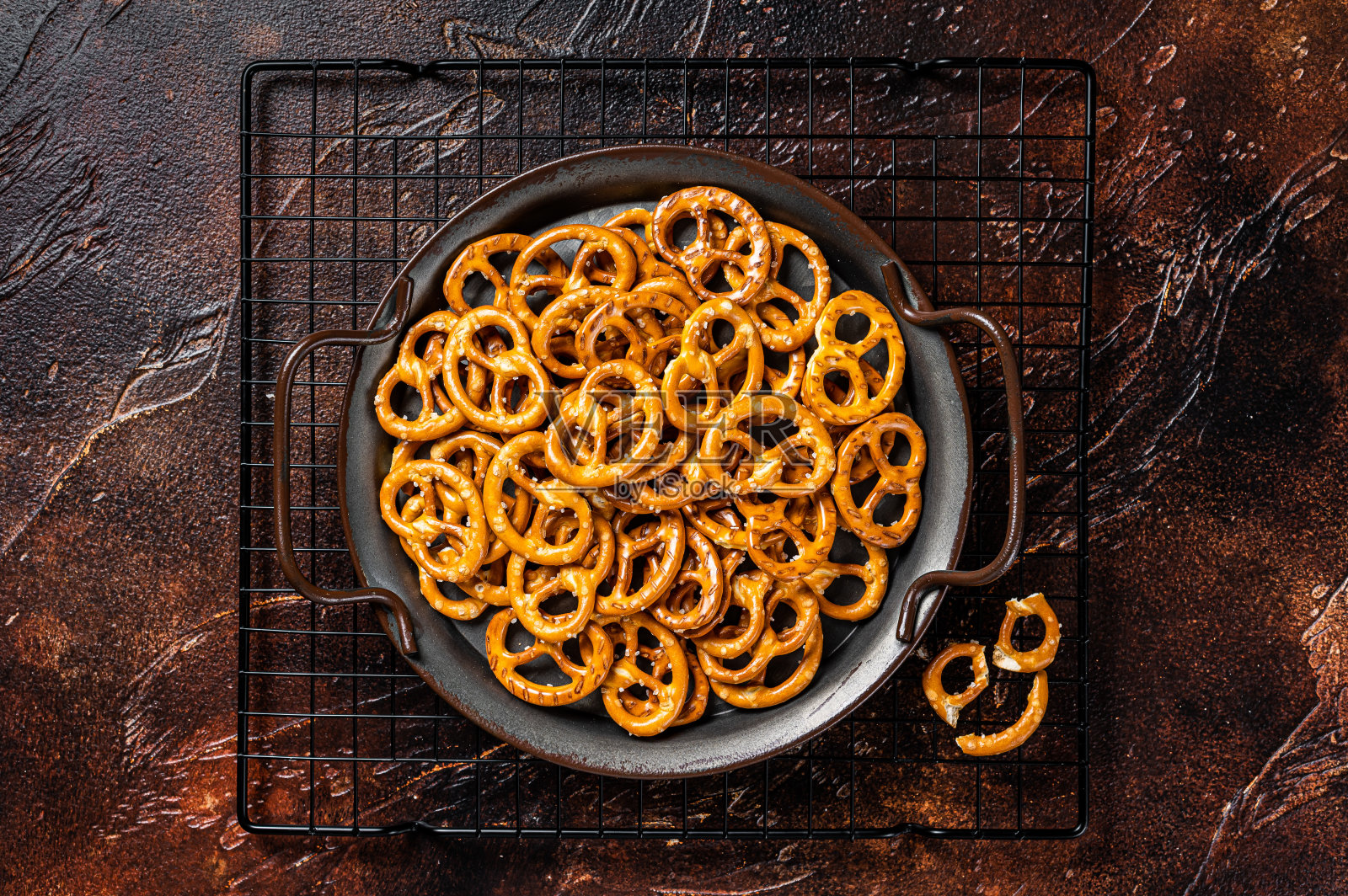 加盐的椒盐脆饼。黑暗的背景。俯视图照片摄影图片