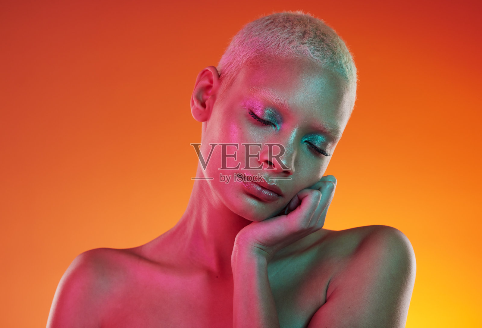 Skincare, beauty and neon cosmetics, woman with face makeup and light in creative advertising on orange background. Cyberpunk, product placement and model isolated in future mockup space in studio.照片摄影图片