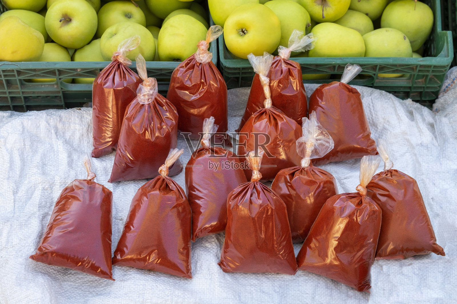 当地食品市场上，一袋袋装在塑料袋里的红辣椒和绿辣椒正在出售照片摄影图片