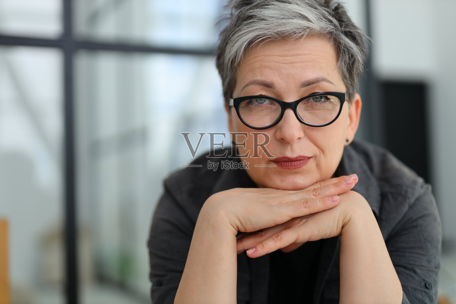 一位戴眼镜的资深女商人的肖像。照片摄影图片