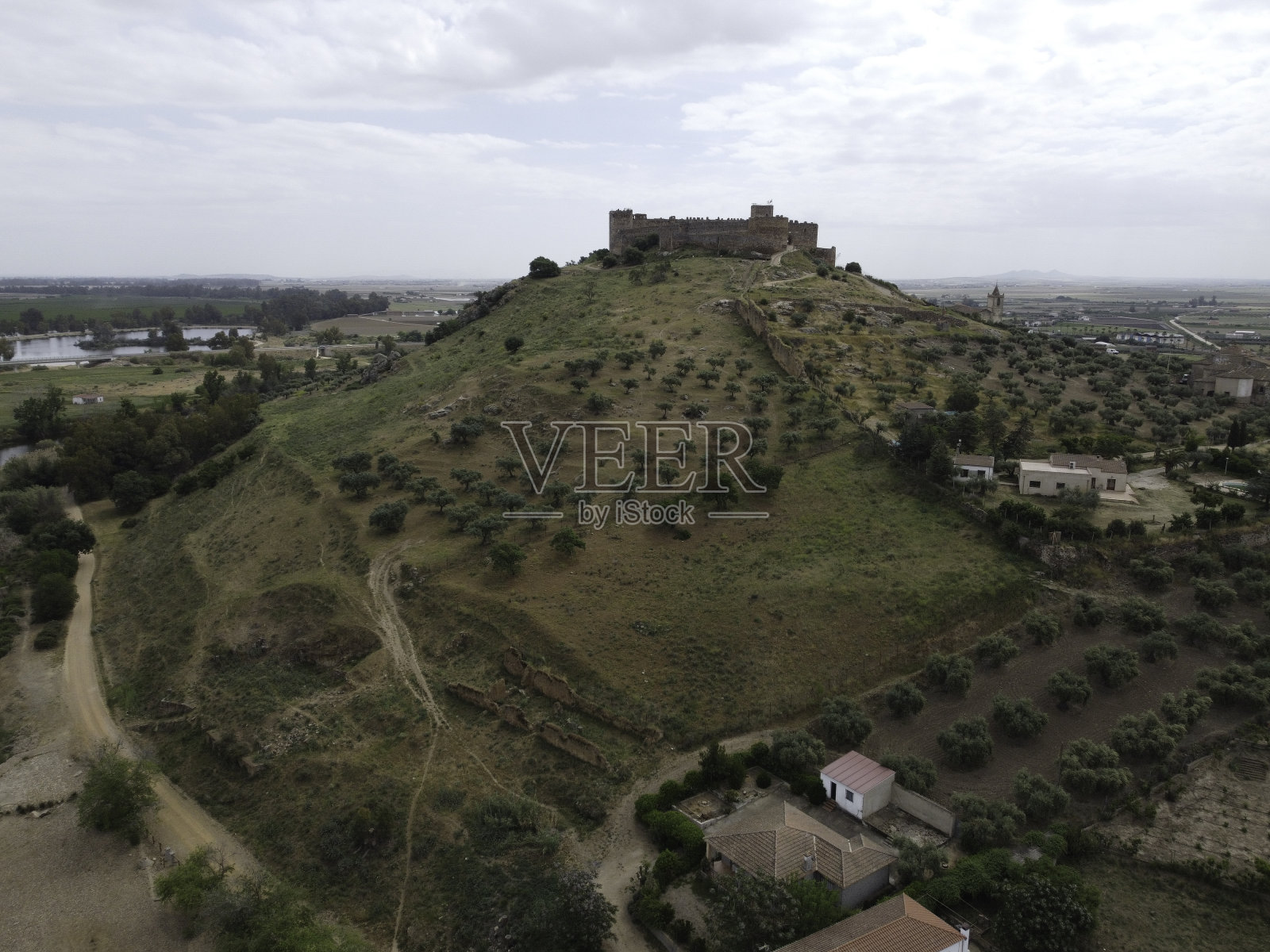 麦德林有西班牙瓜迪亚纳河上的城堡和古老的石桥，照片摄影图片