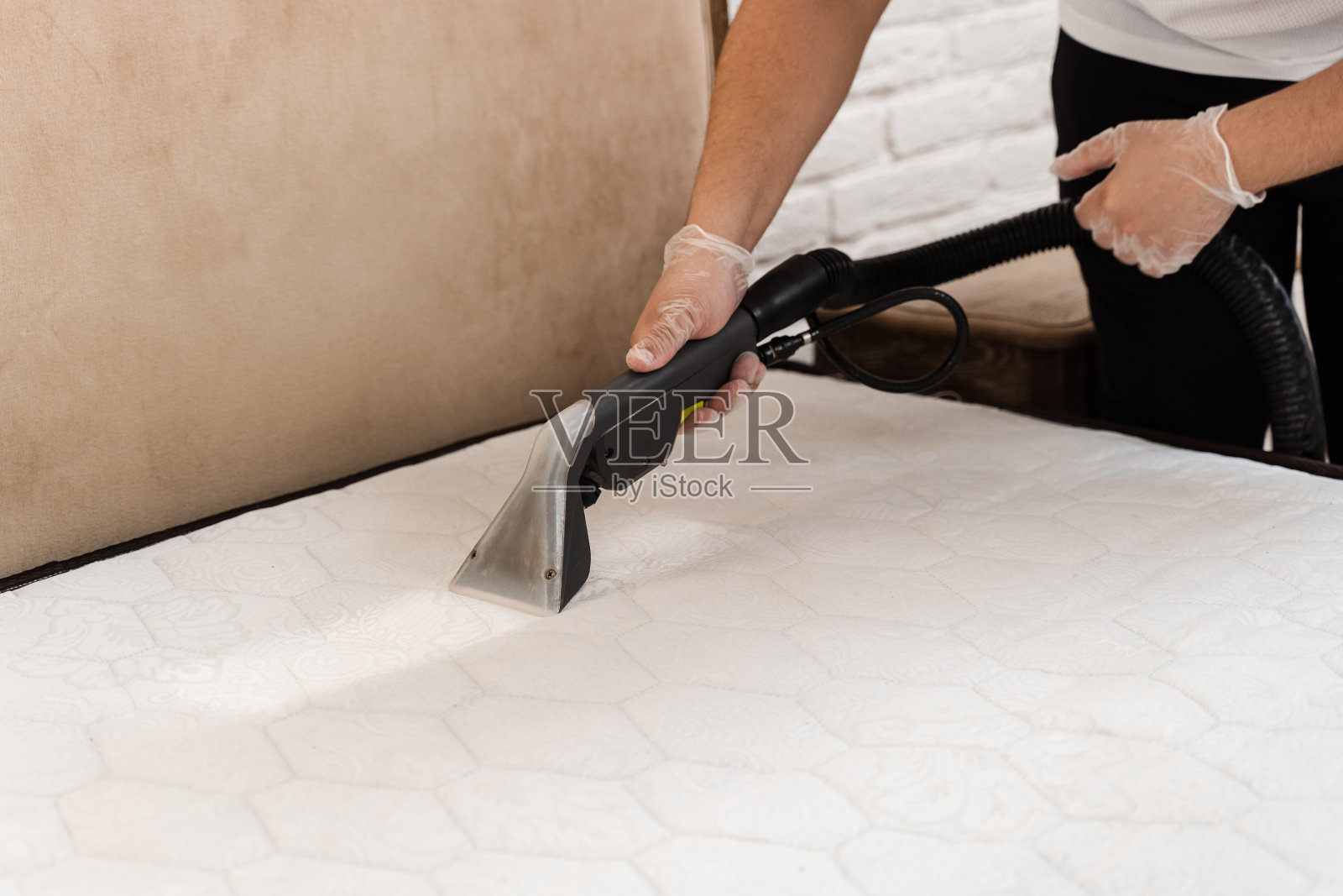 干洗萃取机提取水和洗涤剂后，在床垫上划线。干洗清洗机是使用干洗萃取机去除床垫上的污垢和灰尘。照片摄影图片