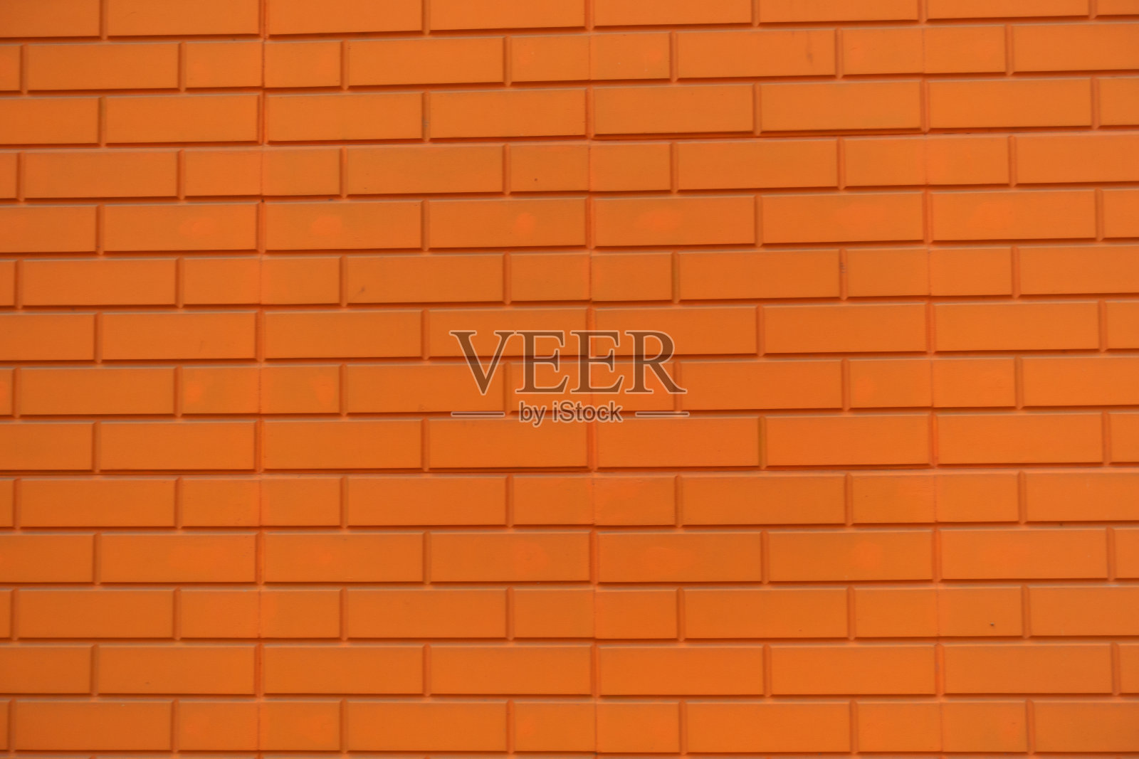 纹理明亮的橙色砖贴面墙照片摄影图片