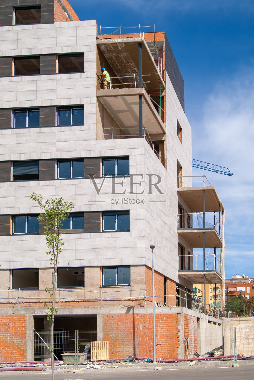 在建筑阳台上工作的瓦匠。正直的形象。照片摄影图片