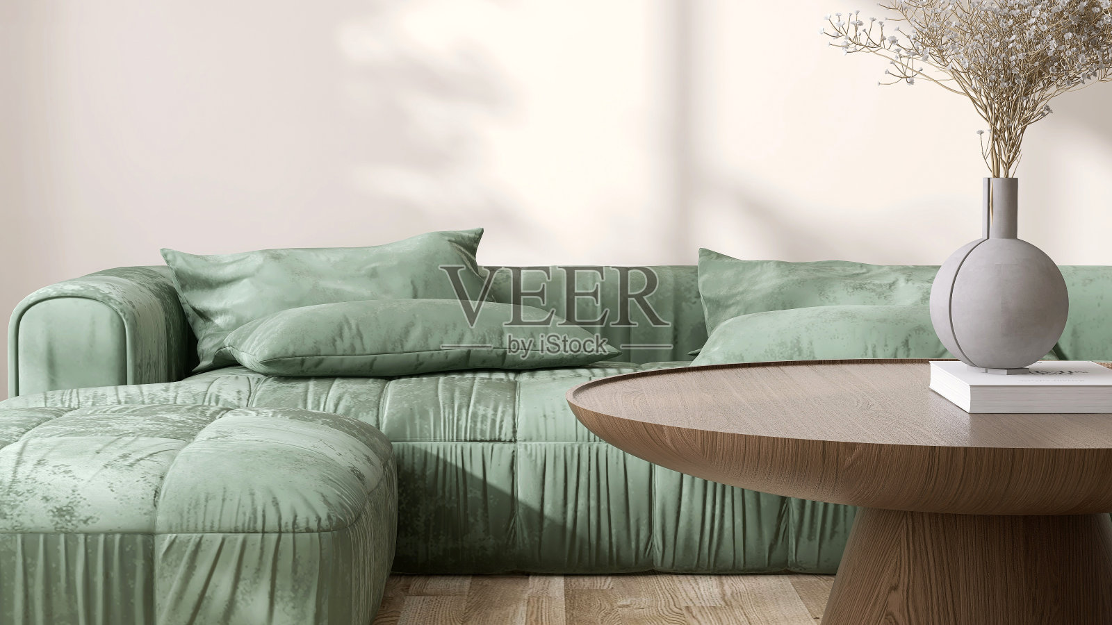 圆形，现代，美丽的纹理木咖啡桌裙台，绿色天鹅绒厚垫沙发在阳光下，奶油色的墙壁，拼花地板照片摄影图片