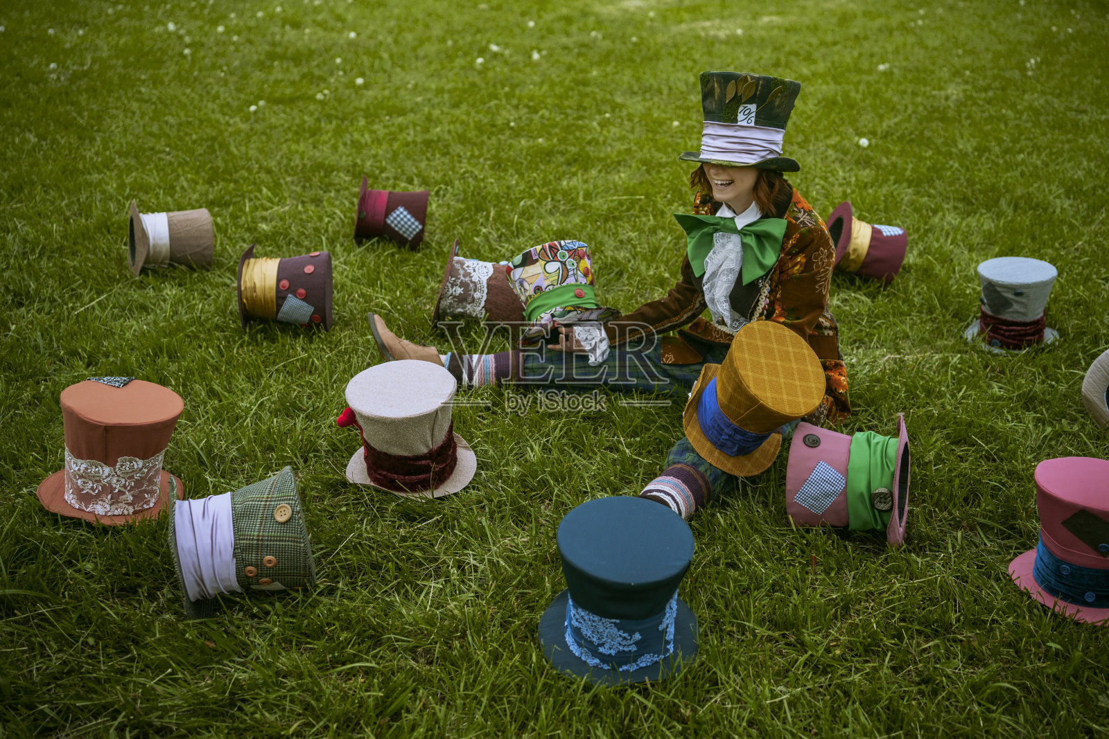 美丽的女人就像疯帽子匠，戴着自然的帽子照片摄影图片