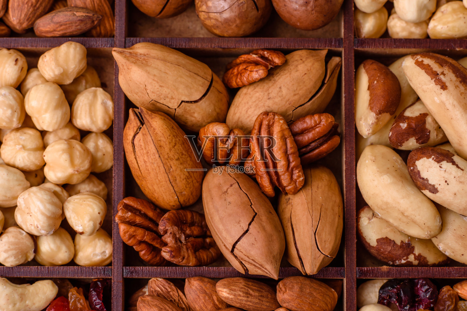 混合烤澳洲坚果，腰果，山核桃，杏仁，葡萄干和干浆果照片摄影图片