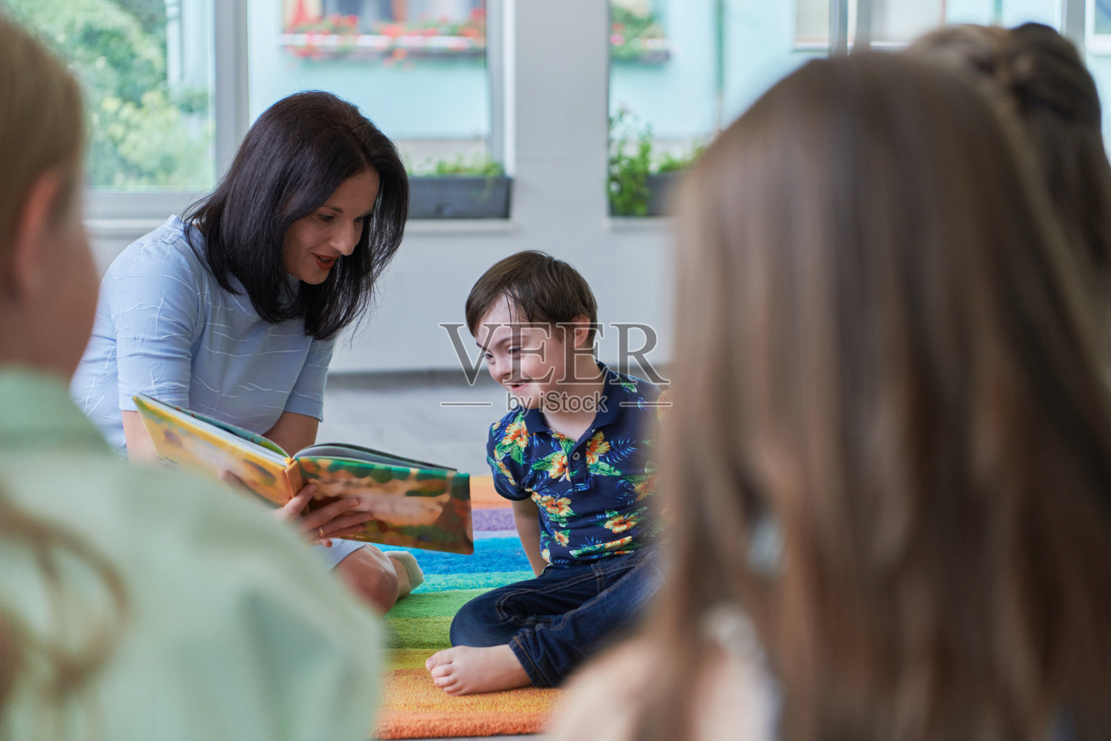 小学或幼儿园的阅读时间，老师在小学或幼儿园给孩子们读书。学前教育的概念。有选择性的重点照片摄影图片