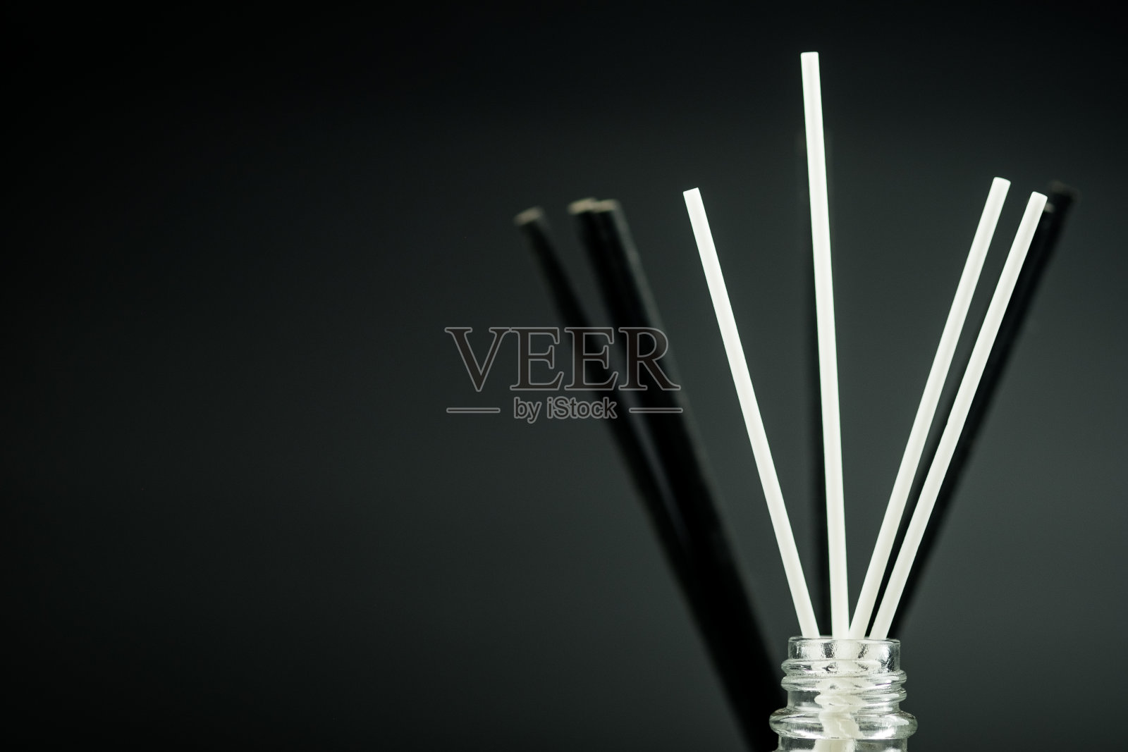 香水扩散器香水清新剂与黑色和白色棒在黑色的背景与空间的文字。照片摄影图片