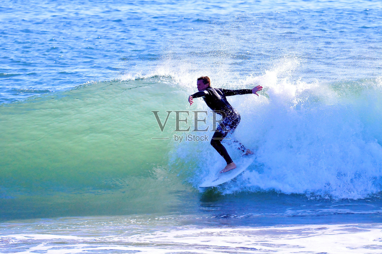 阳光海浪上的冲浪者照片摄影图片