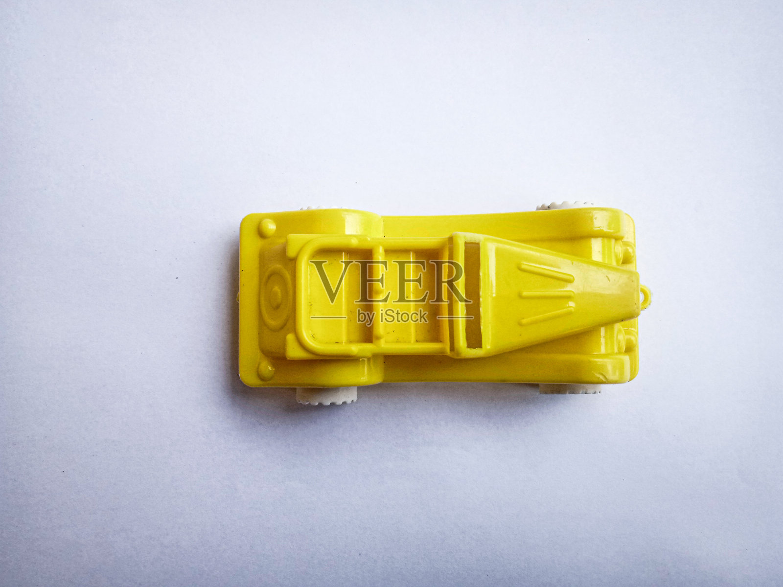 黄色的玩具在白纸上照片摄影图片