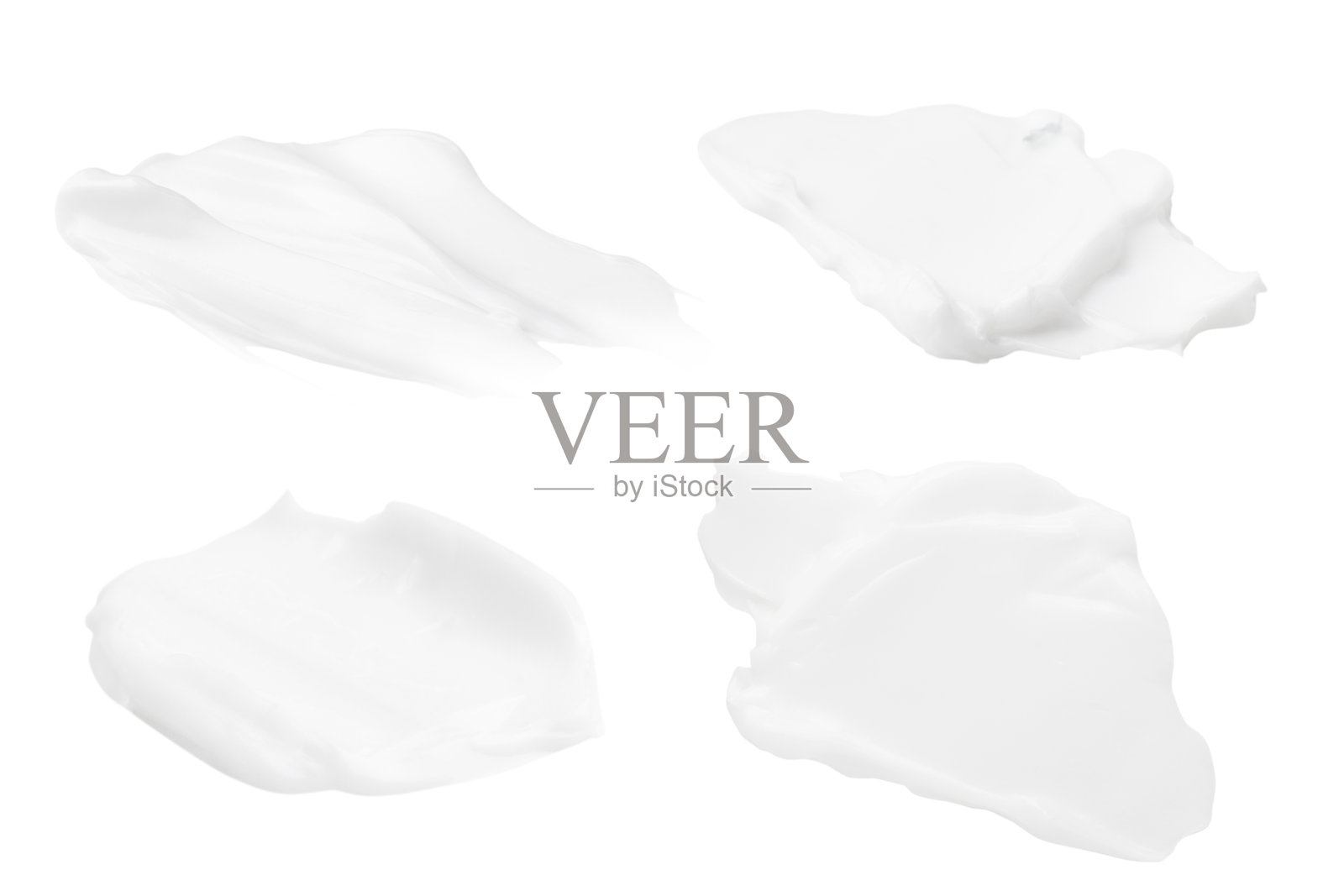 白色背景上的一组不同笔触的白色奶油。照片摄影图片