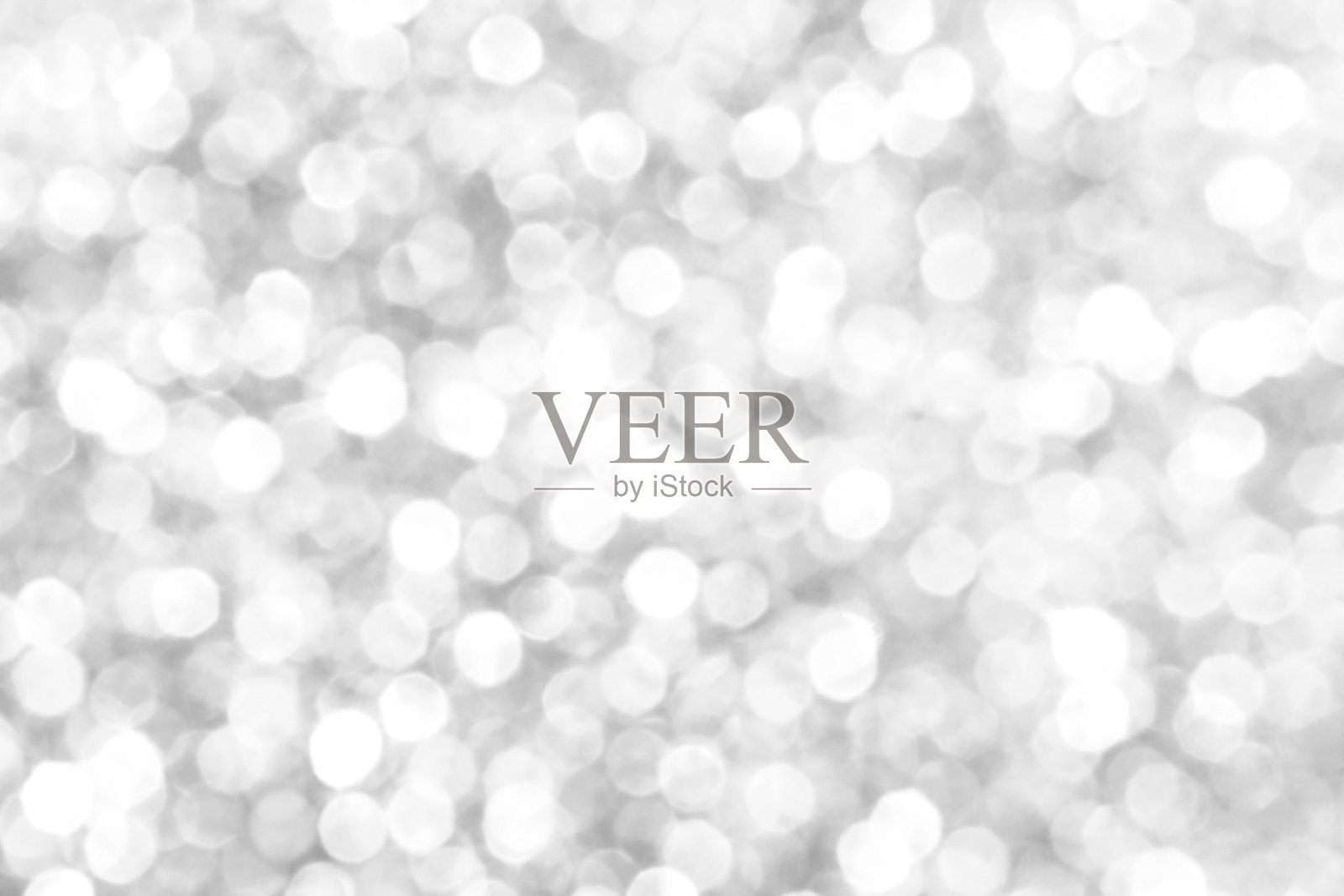 白色和灰色散景闪烁的光背景。照片摄影图片