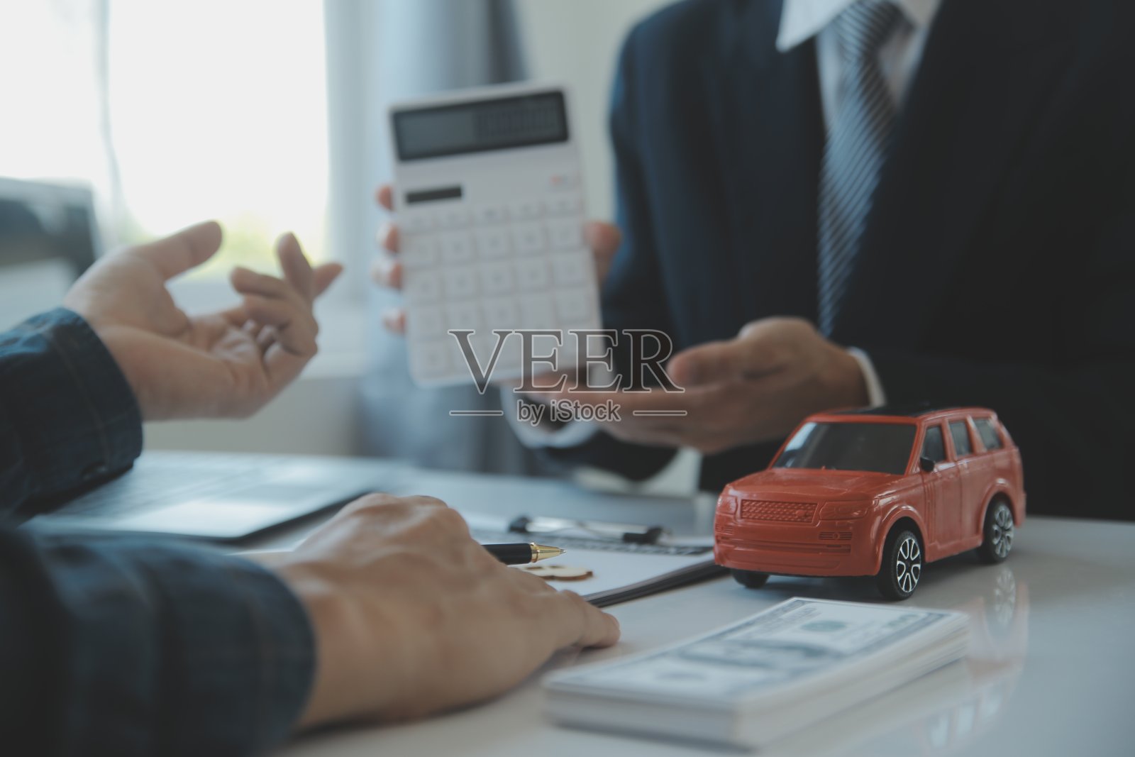 特写亚洲男性汽车推销员或销售经理提供出售汽车，并解释和阅读签署汽车合同和保险的条款。照片摄影图片