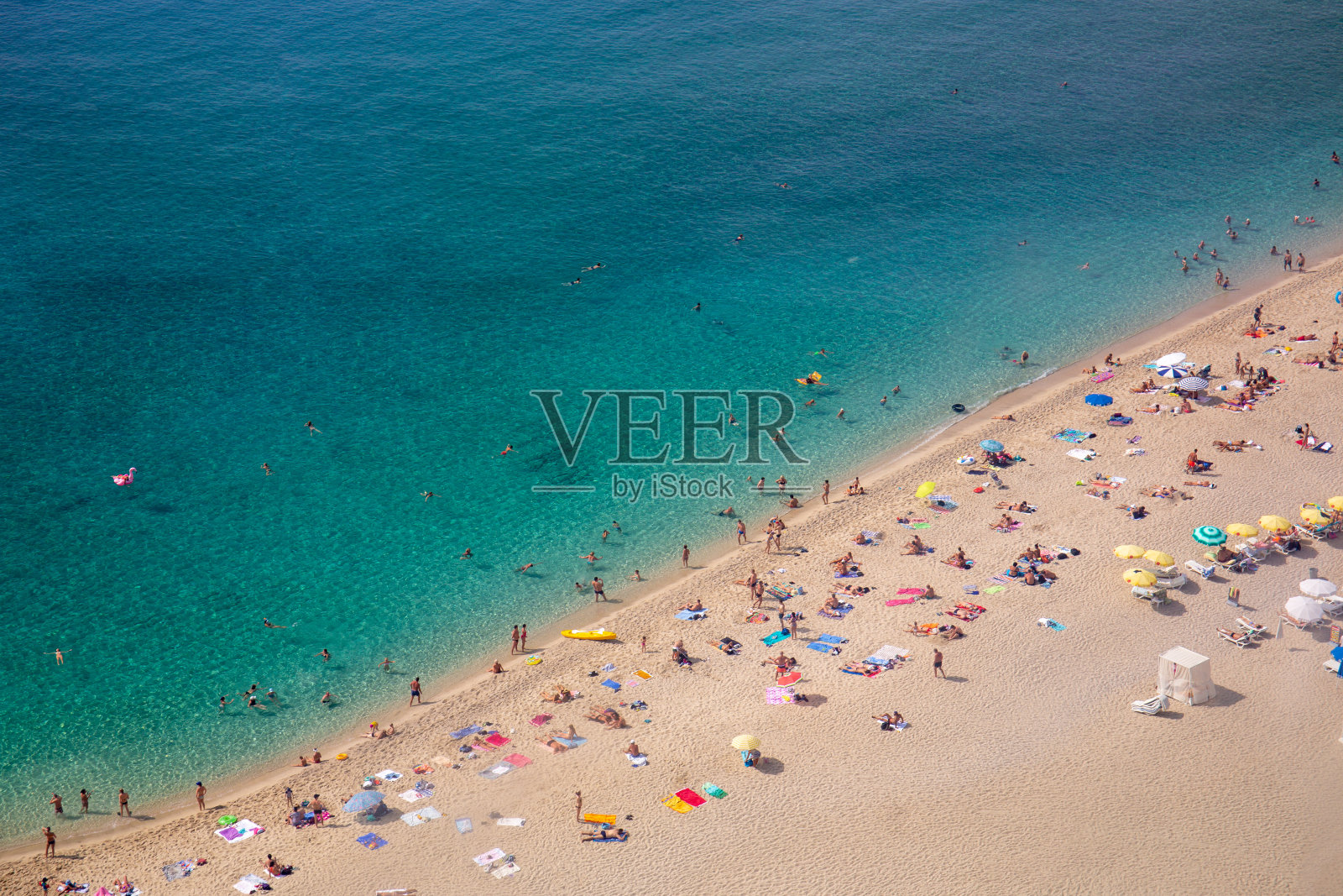 沙滩鸟瞰图，游客在美丽清澈的海水中游泳。人们沐浴在阳光下，在海滩上游泳和做游戏。游客。海中。海滩。夏天。假期。假期。照片摄影图片