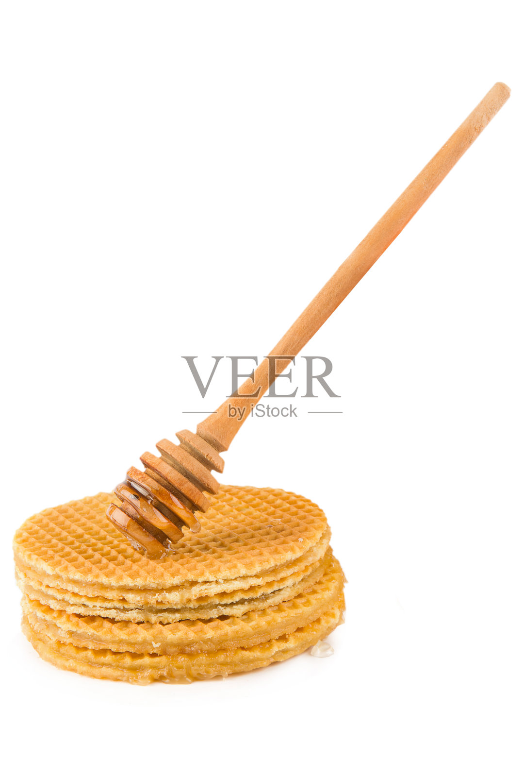 蜜勺和华夫饼隔离在白色。垂直的照片。照片摄影图片