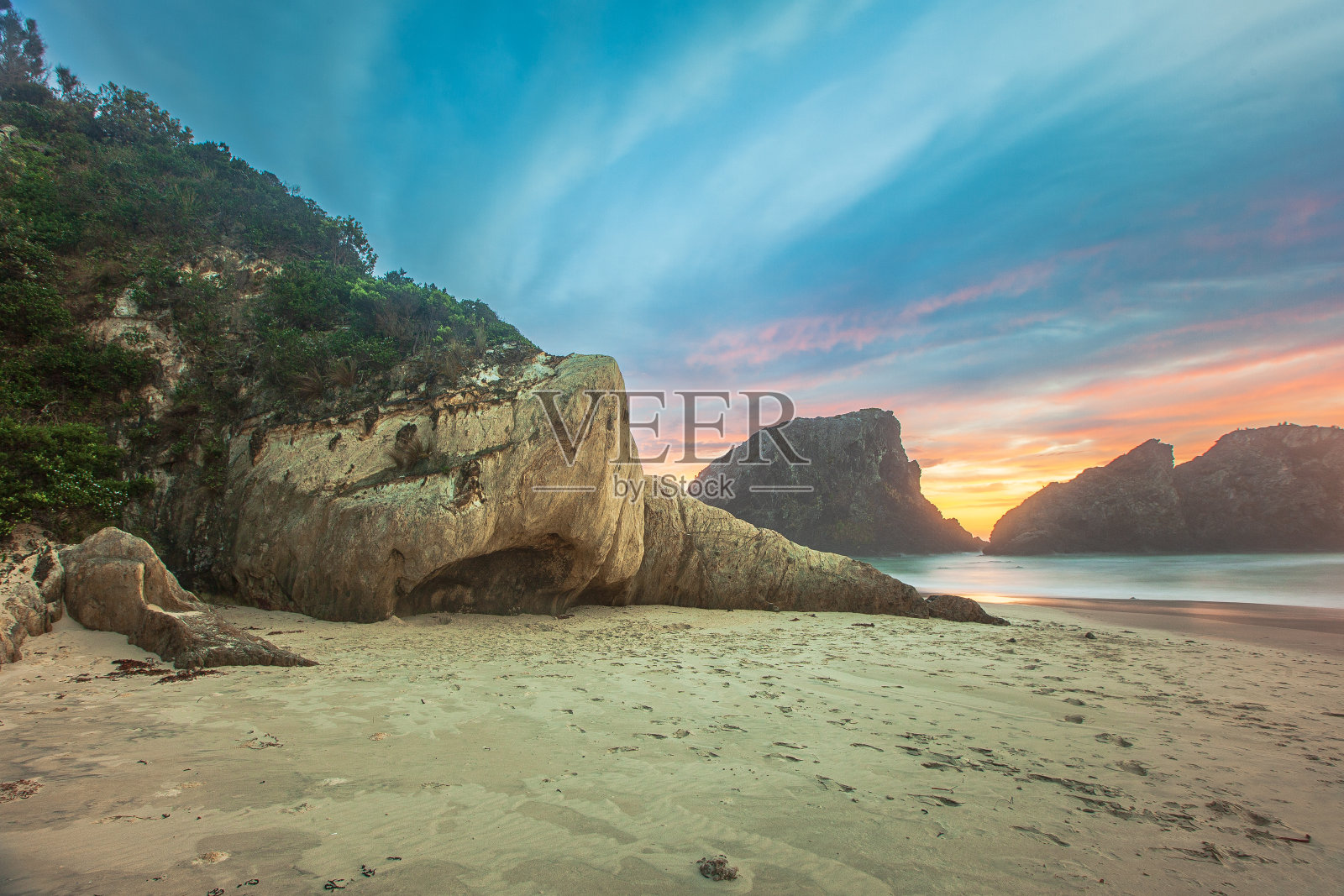 金色日出的海景，戏剧性的天空和独特的海岸岩层照片摄影图片