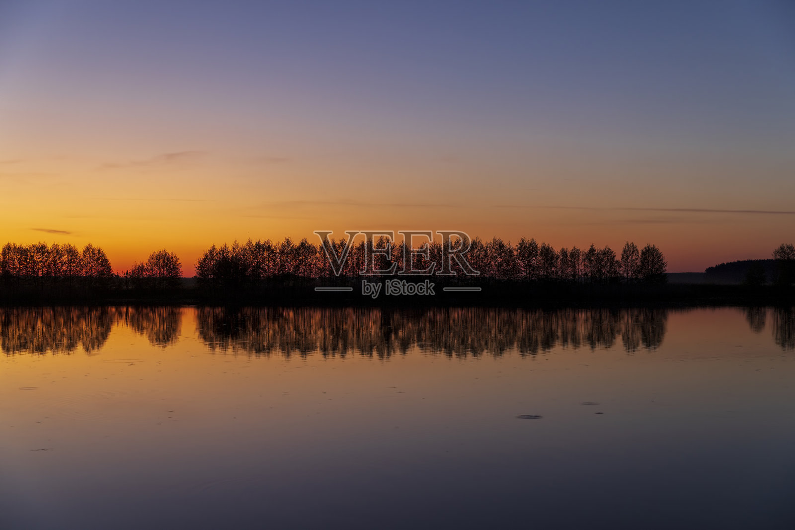 美丽的橘黄色的日落在春天的湖上照片摄影图片