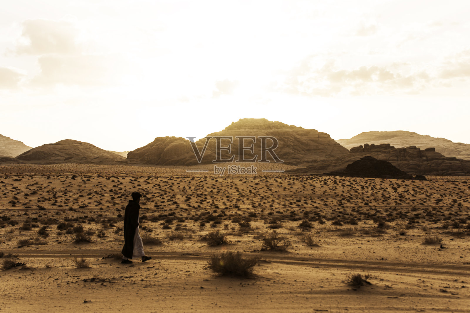 在约旦瓦迪拉姆沙漠中行走的贝都因人照片摄影图片