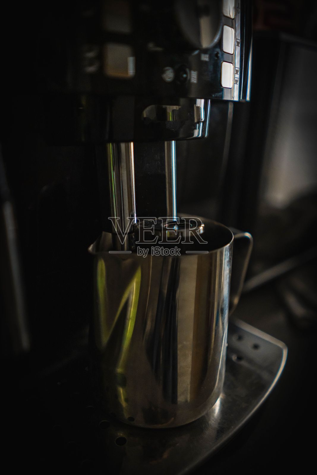 台面上放着一个金属杯的压水机照片摄影图片