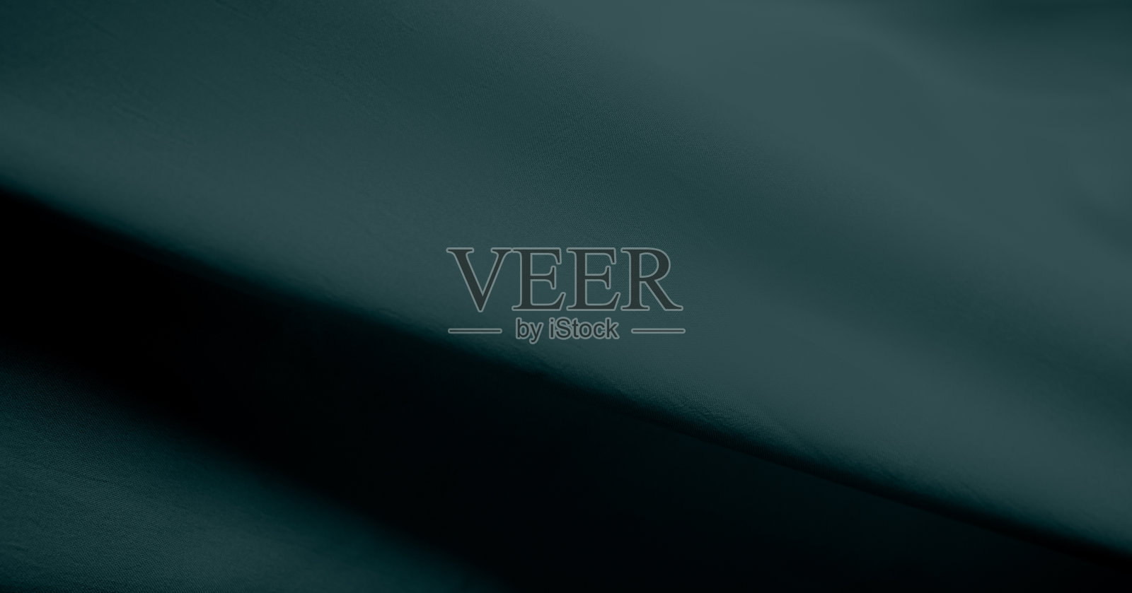 绿色面料纹理真丝背景，奢华的布料图案时尚，抽象波软材料，深天鹅绒翡翠色照片摄影图片