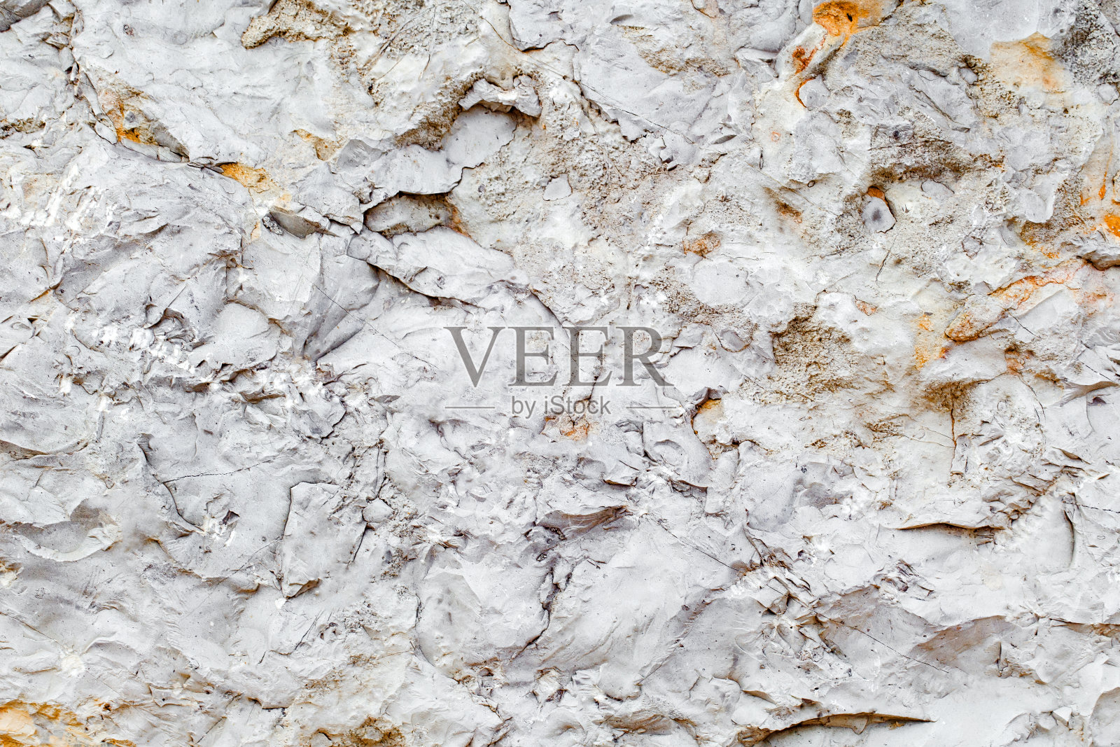 背景石表面凹凸不平，纹理均匀灰黄色照片摄影图片