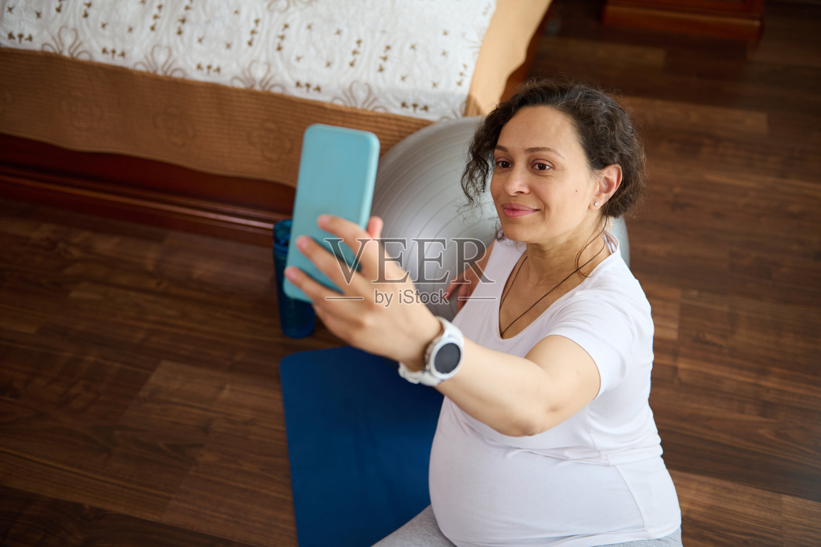 近景孕妇自拍，伸展运动后放松，在怀孕期间保持身材照片摄影图片