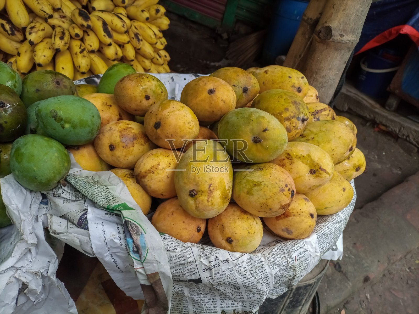 排列成熟和未成熟的芒果和香蕉。照片摄影图片