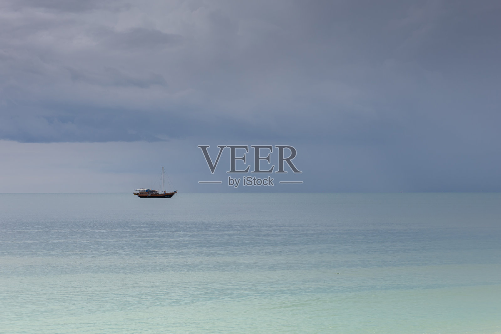 一艘船在海中央照片摄影图片